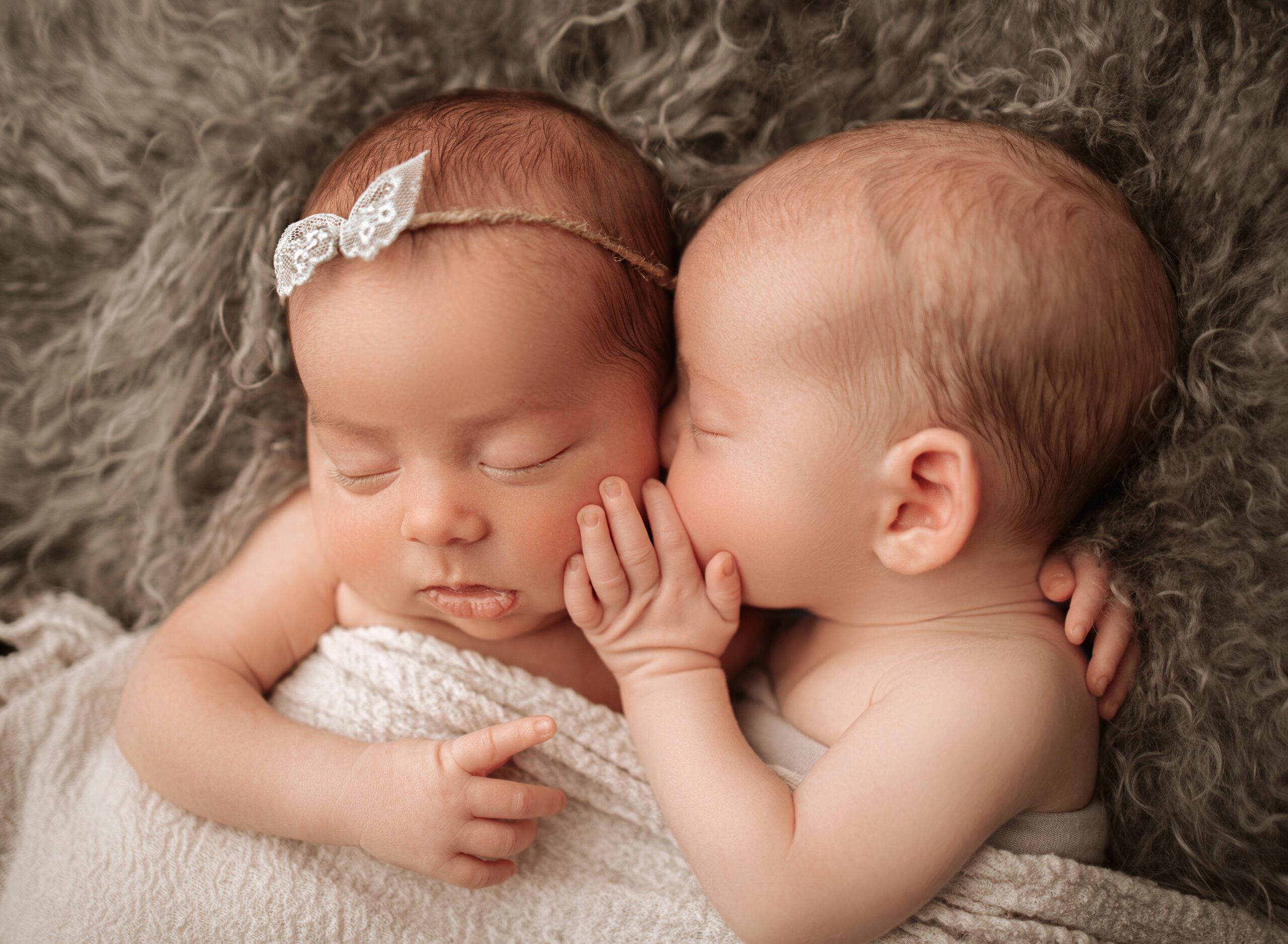 Newborn twins laying next to each other during professional photoshoot on Boca Raton
