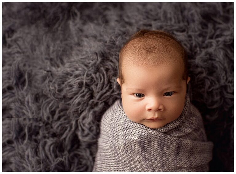 Newborn Baby boy wrapped in blue knit