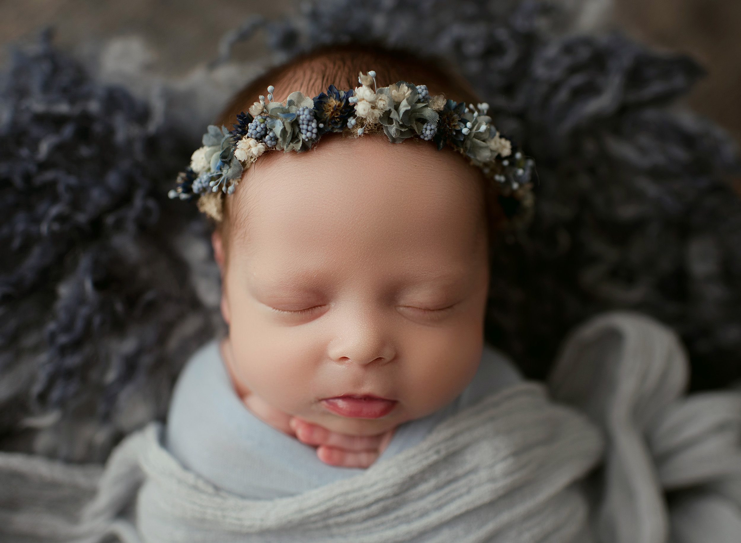Baby girl with blue linen wrap and blue flower crown