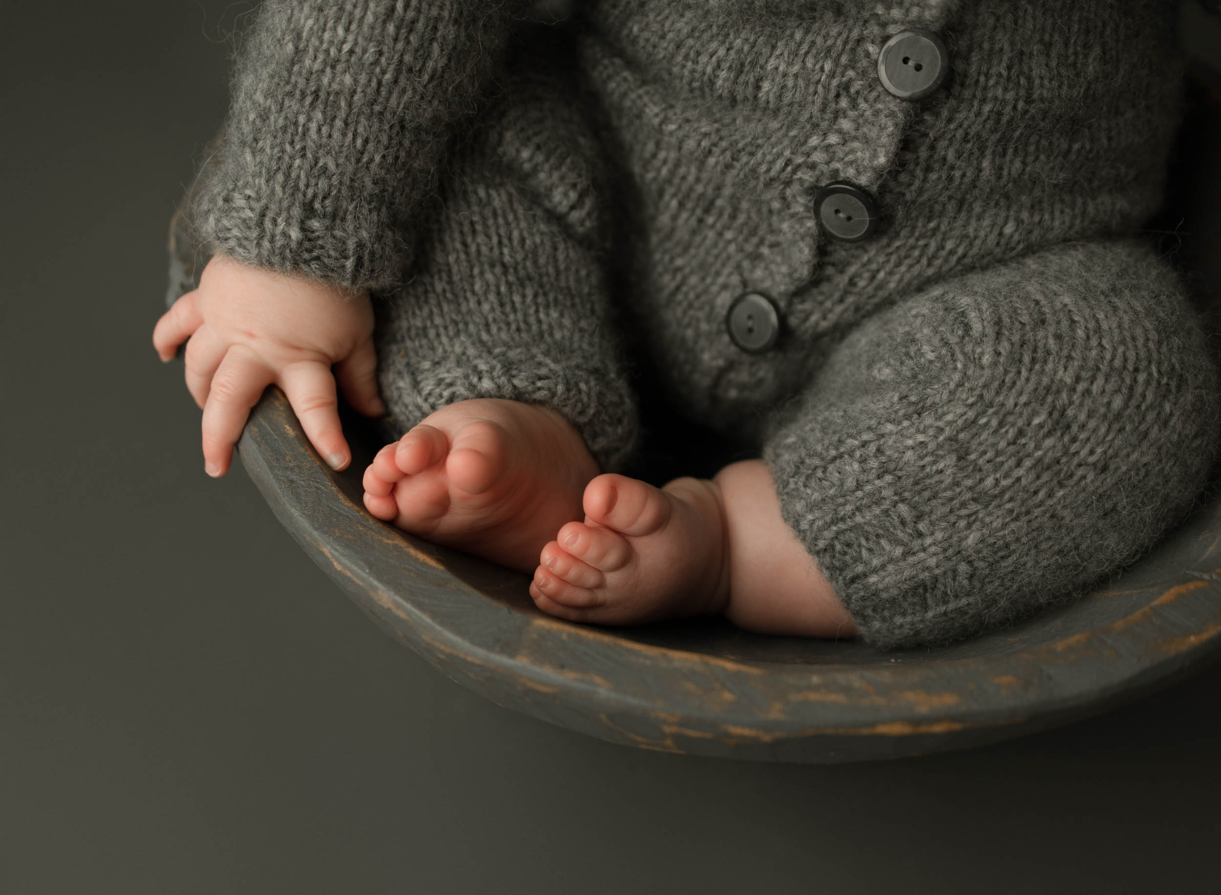 close up of the cutest baby toes - baby is sitting in gray bowl