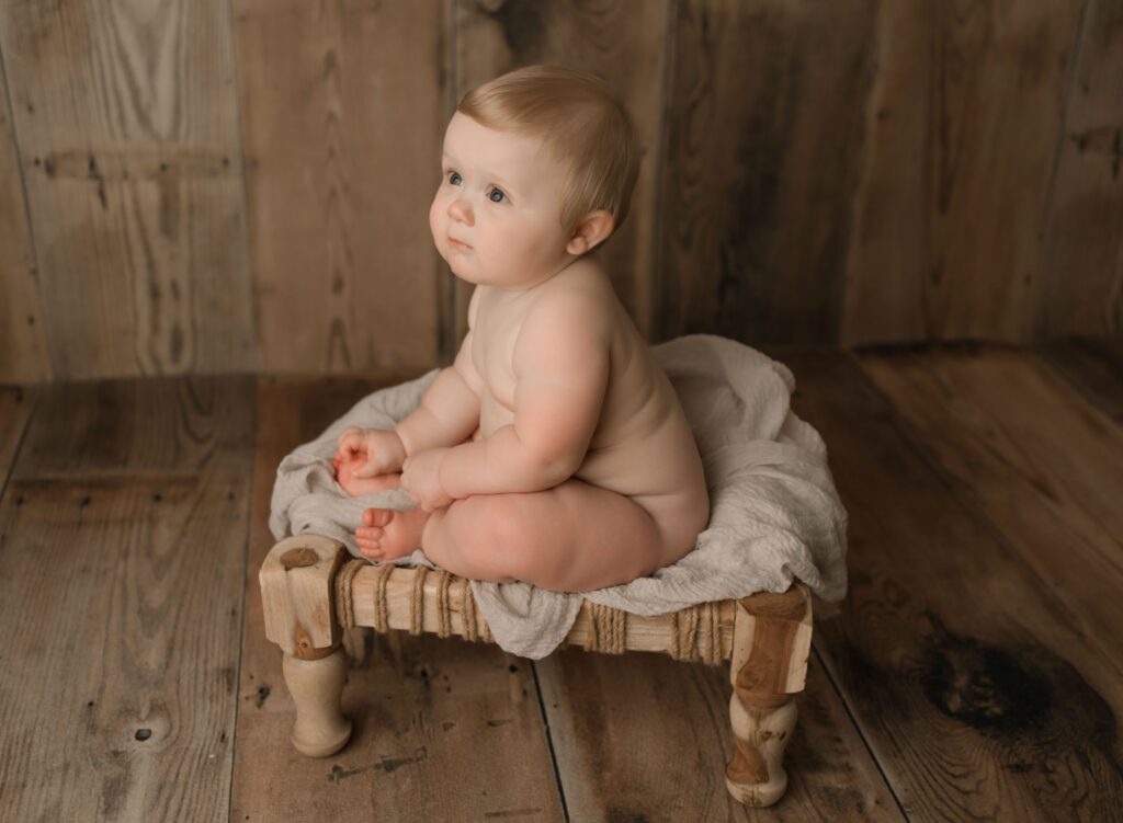 adorable blonde baby boy sitting on a boho stool during his baby photography west palm beach photoshoot