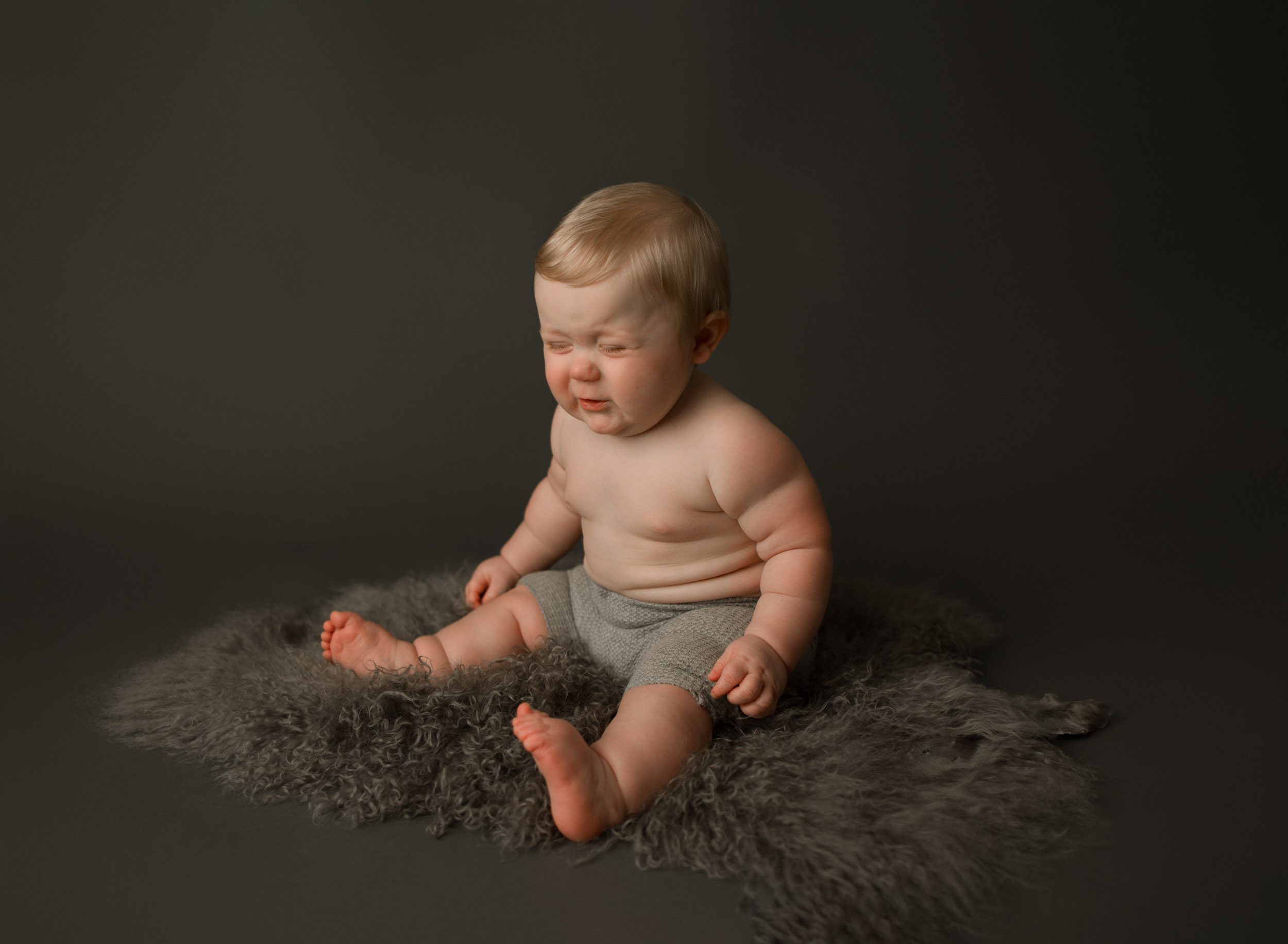 9 month old baby boy pouting for his photo shoot