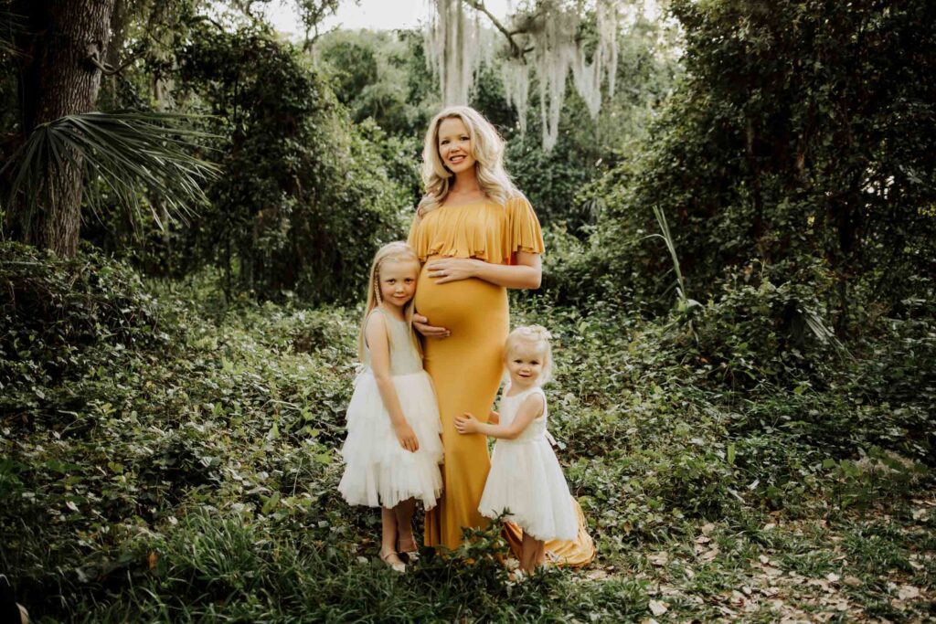 expecting mom posing with her two daughters during a Fort Lauderdale maternity photoshoot