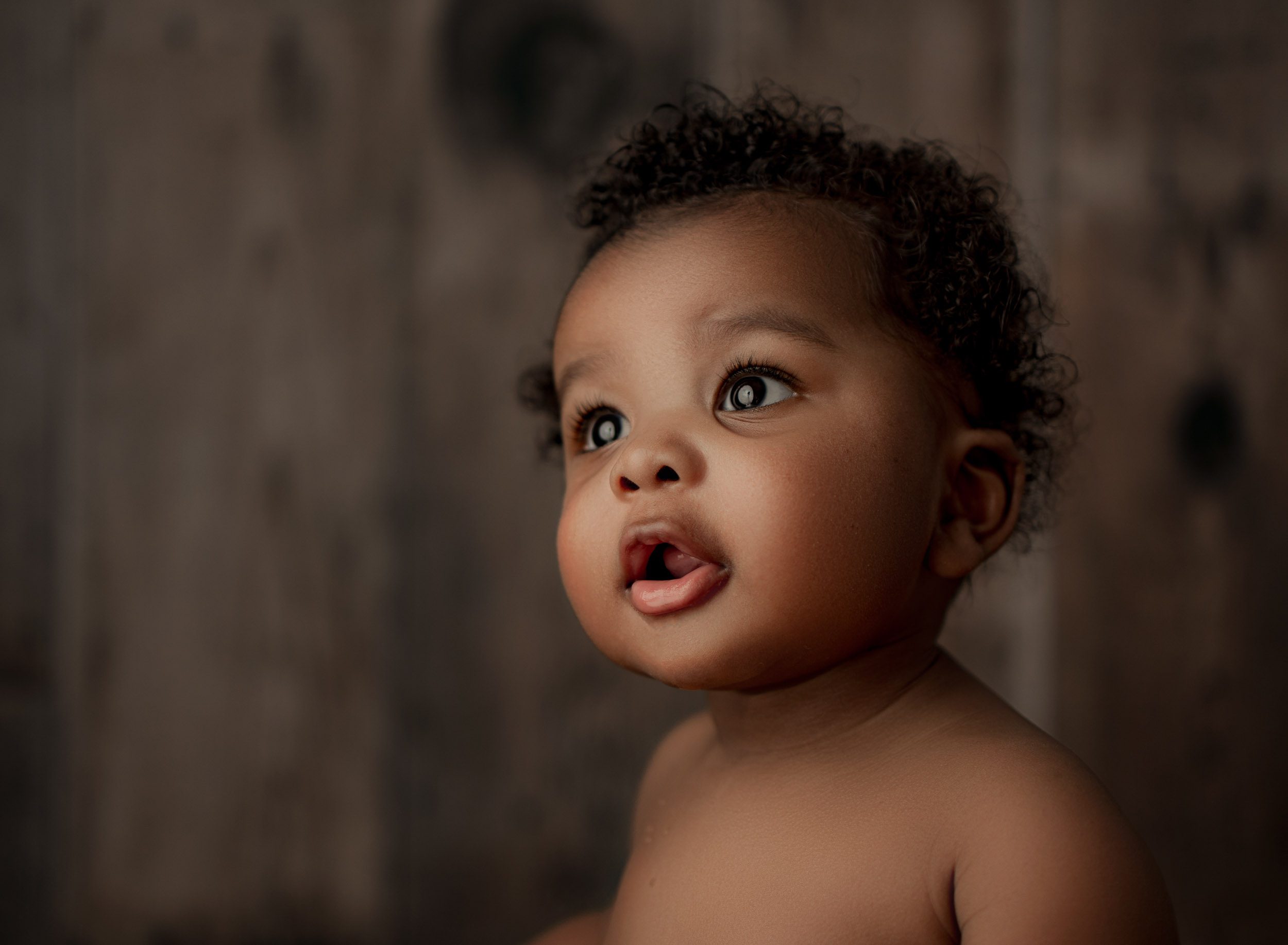 8 month old baby looking off camera at a Boca Raton photoshoot