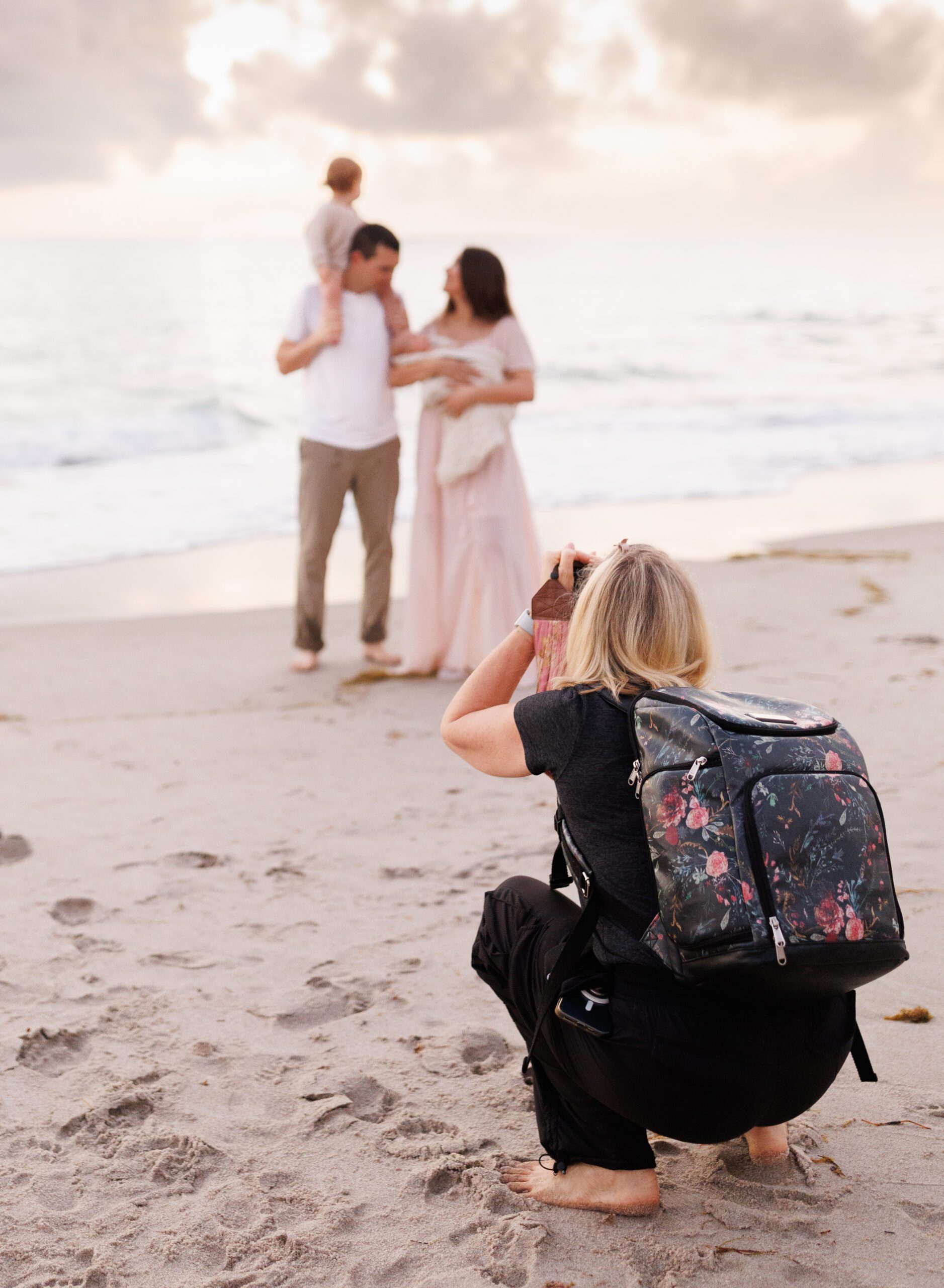 photographer photographing a family on the beach