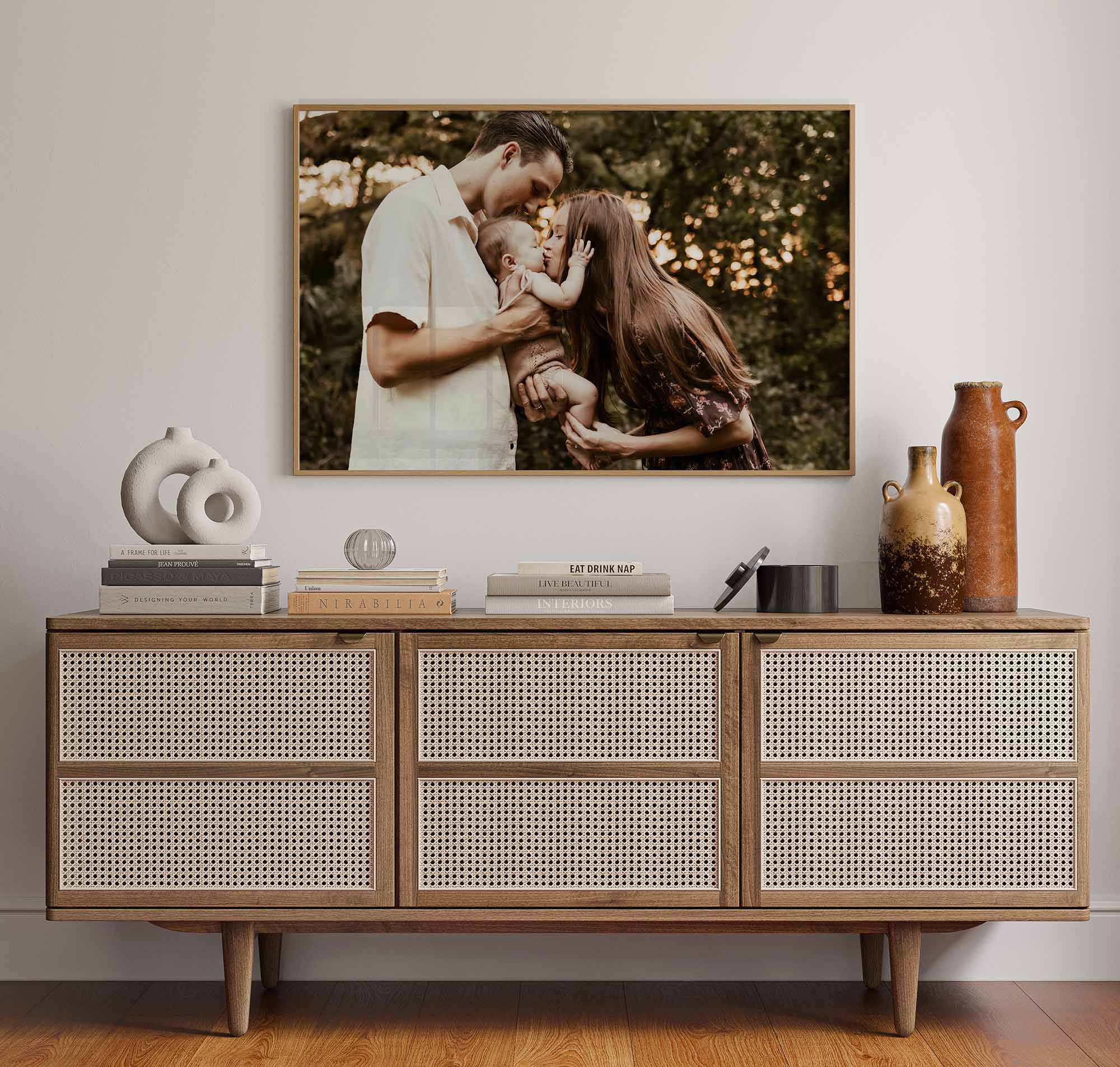 mom kissing her toddler while dad holds baby during an outdoor fort lauderdale family photoshoot