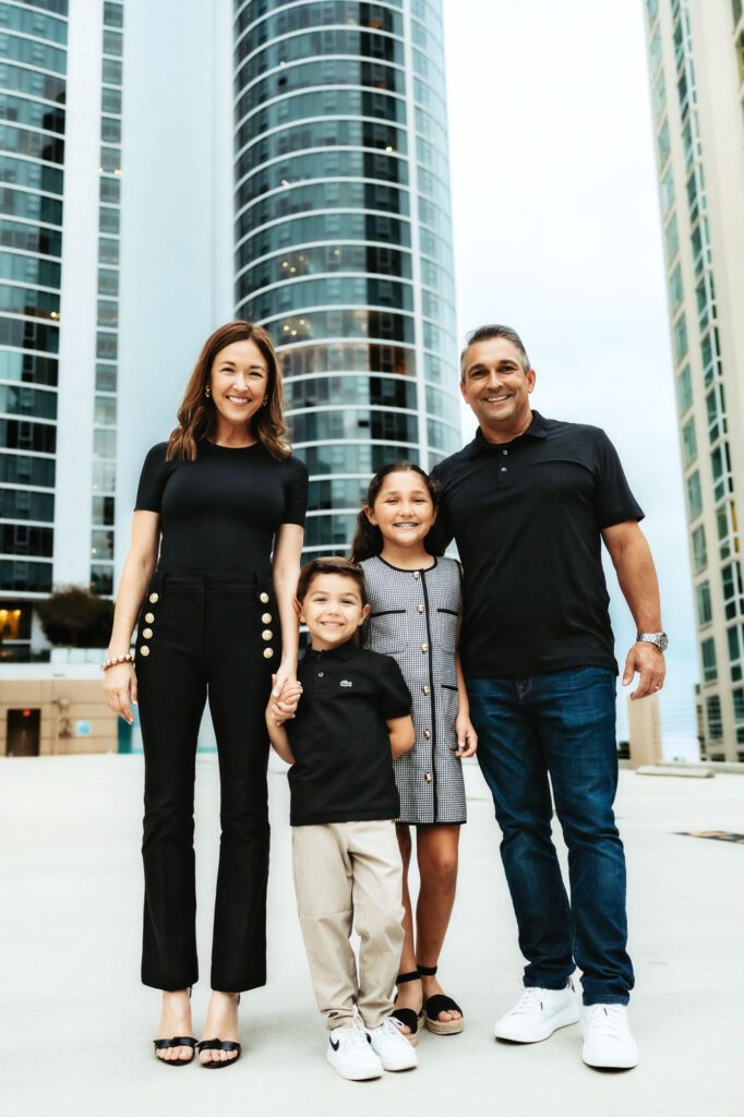 family of four posing together during a professional photoshoot in Fort Lauderdale