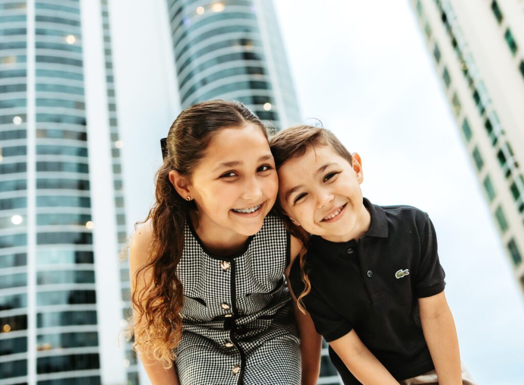 two siblings hugging during an outdoor family photoshoot in Fort Lauderdale