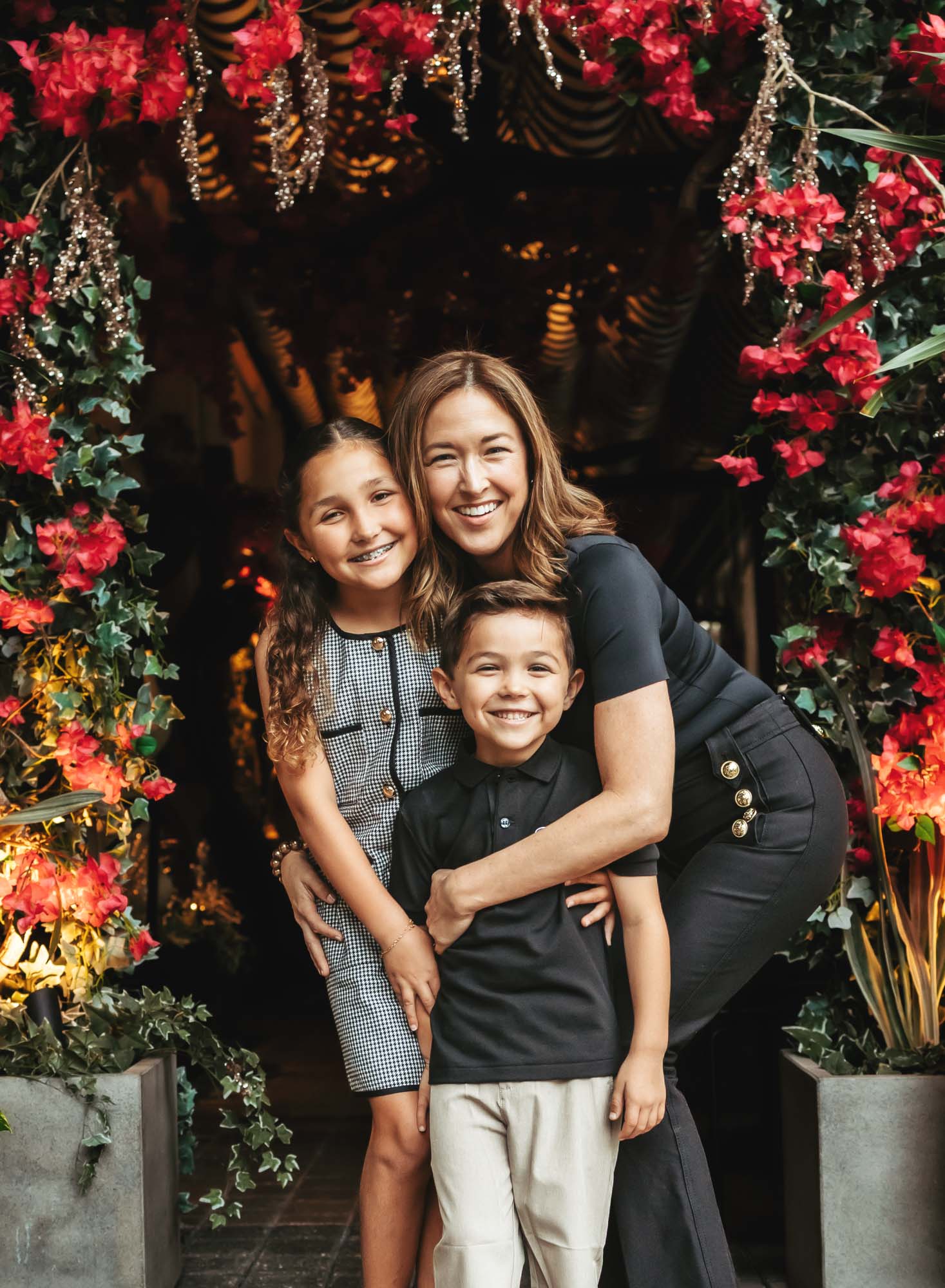 Mama and her kiddos in front of a decorated storefront on Las Olas Blvd in Fort Lauderdale for their annual family photos.