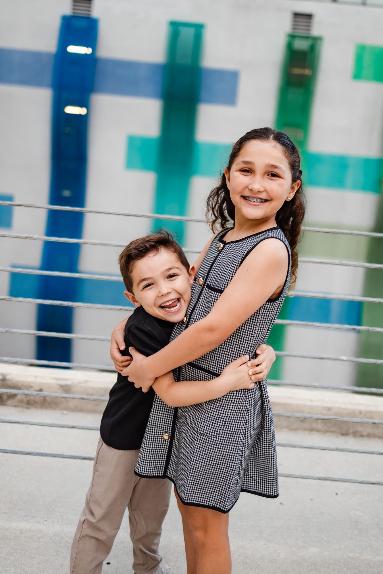 Brother and sister hugging and smiling for their downtown family photoshoot in Fort Lauderdale.