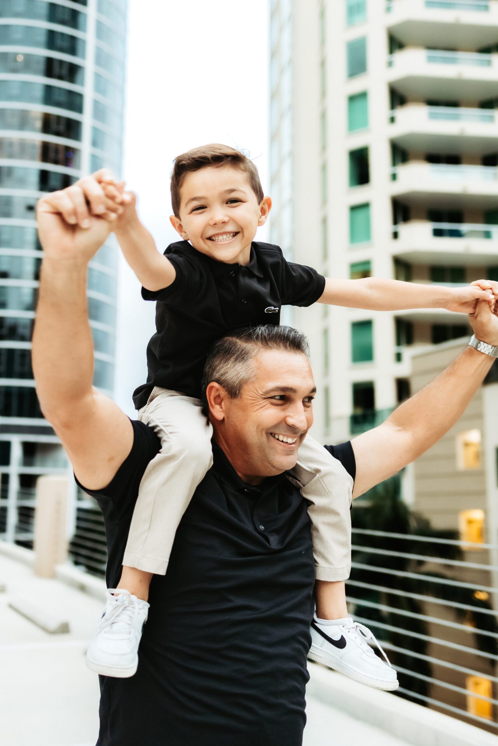 Son on Dads shoulder in Fort Lauderdale, FL during family photoshoot