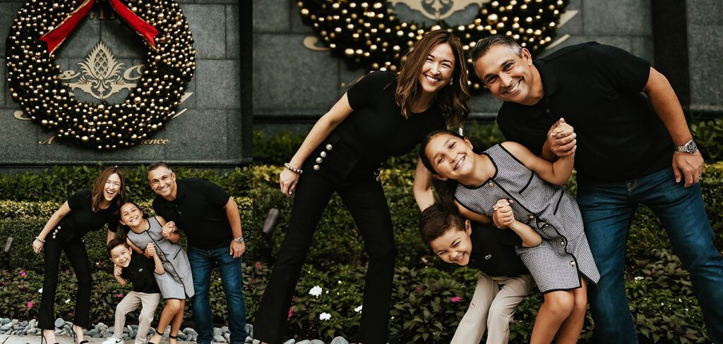 Family having fun in front of holiday hotel wreaths, Fort Lauderdale, FL