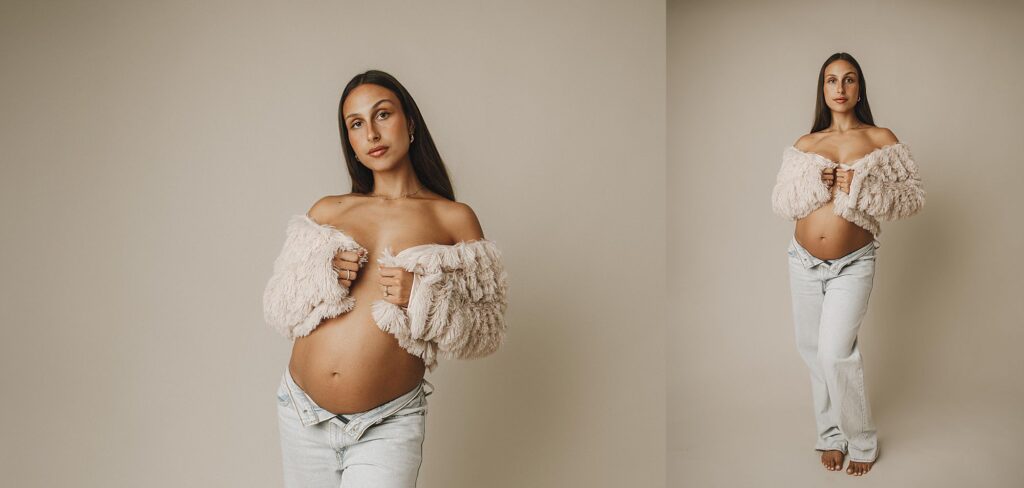 expectant mom in studio for maternity photoshoot. mom in jeans with a fuzzy jacket with baby belly exposed