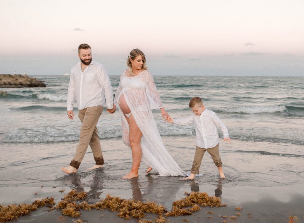 maternity photoshoot ideas for a family of three at a beach session