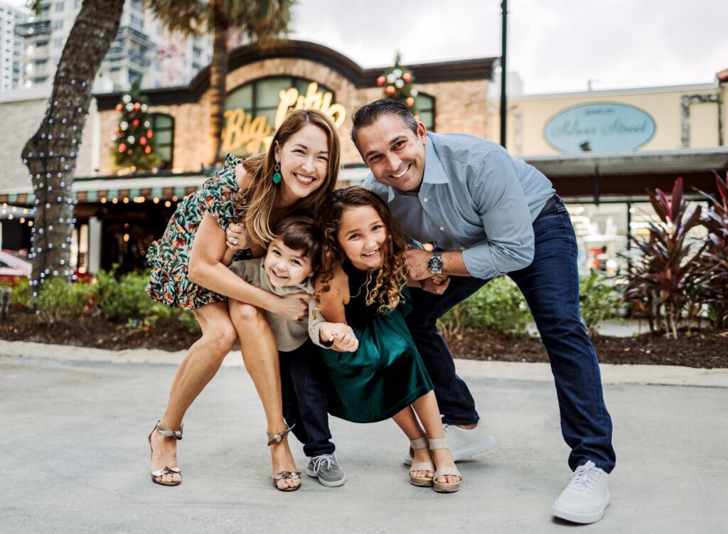 A family smushed together with parents cuddling in a kid height