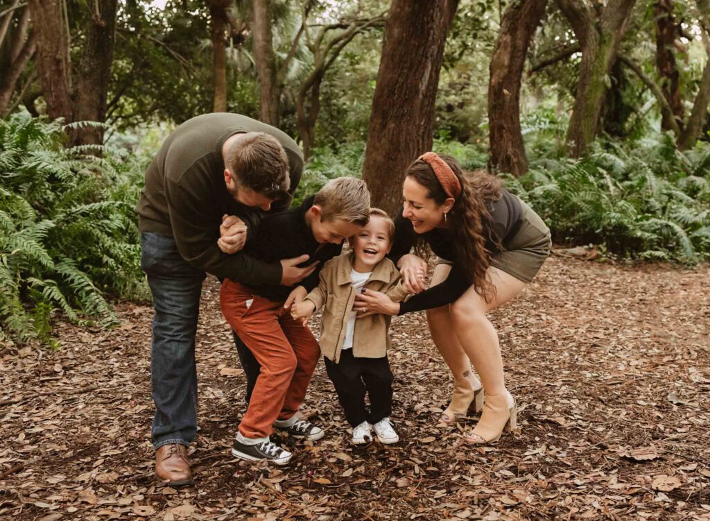 Tickle fest with parents and two sons at their family photo session in Deerfield Beach