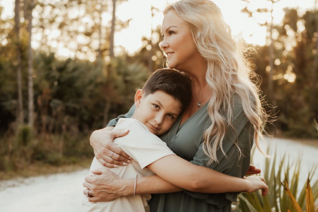 Mom and son snuggle at golden hour photoshoot