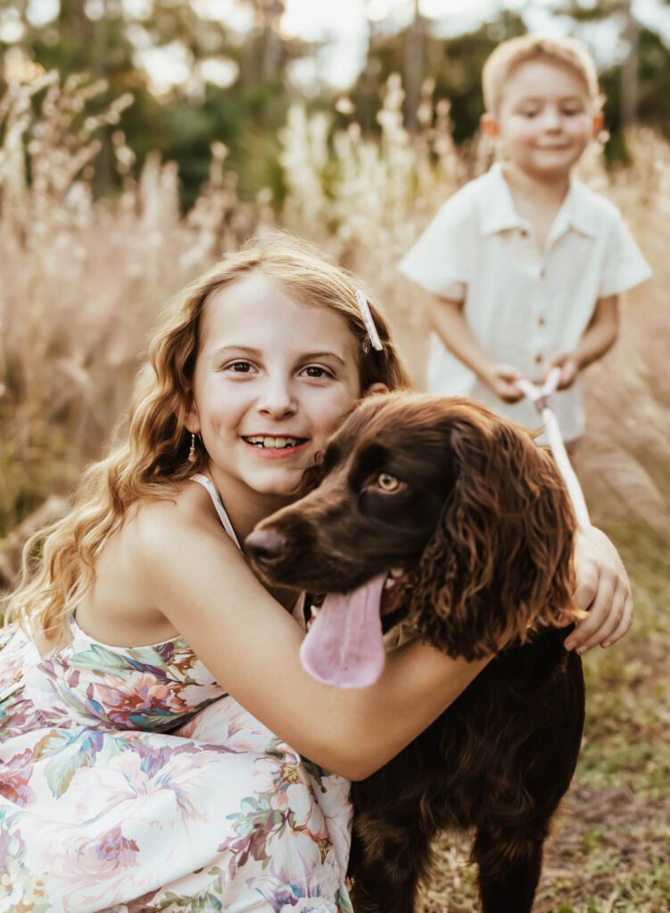 Family photoshoot with their dog. An outdoor photo pose idea in West Palm Beach