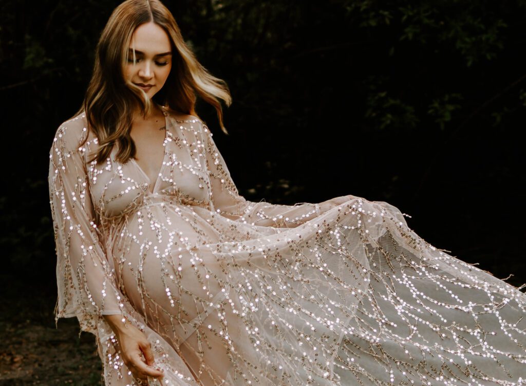 expectant mom in sparkly dress showing maternity photoshoot ideas