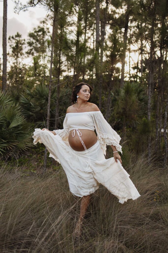 expectant mom in boho outfit wiht belly exposed