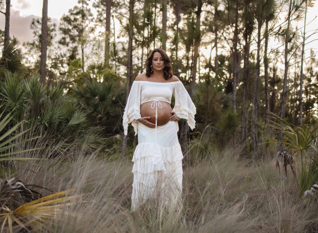 golden hour maternity photo in field
