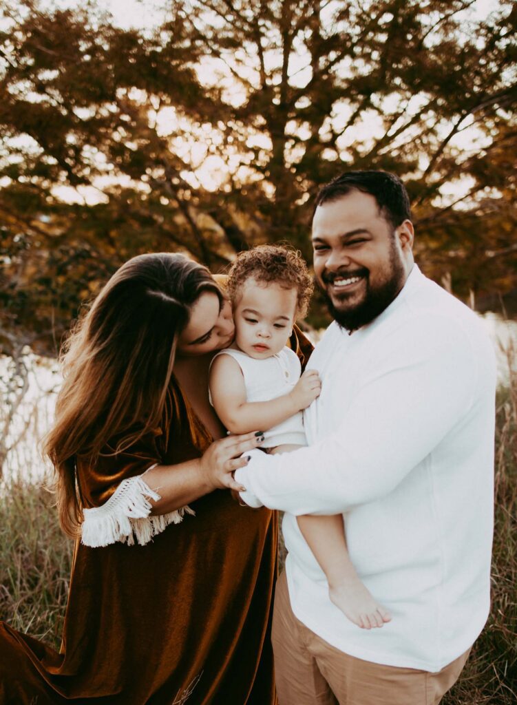 Outdoor family photo idea poses for a family of three in Parkland
