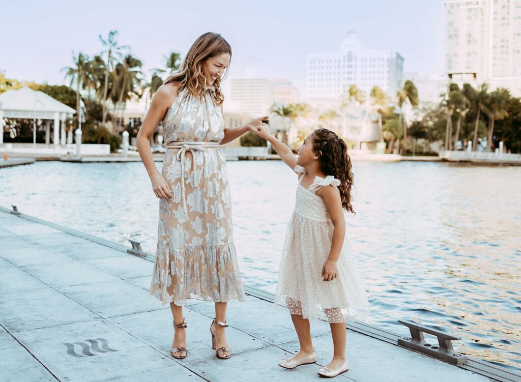 Mother twirling her daughter around on the waterfront in Fort Lauderdale