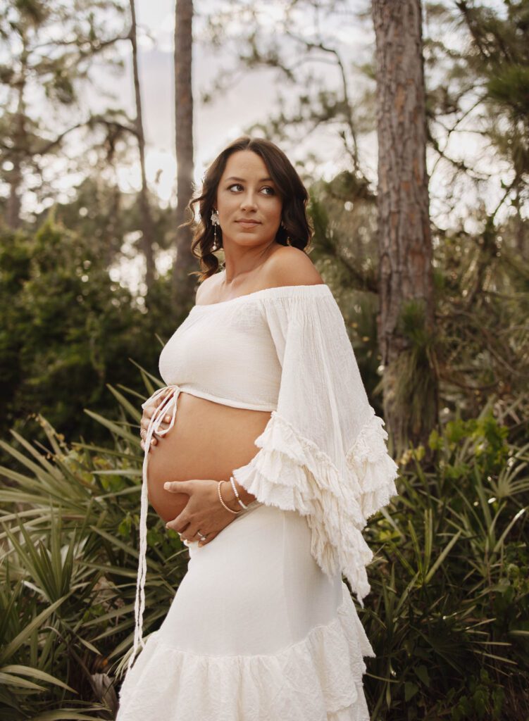 pregnant mom looking over shoulder for maternity photoshoot ideas